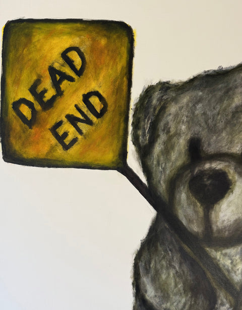 teddy bear looking at a 'Dead End' sign